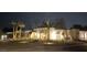 Inviting single-story home exterior at night with desert landscaping and attractive outdoor lighting at 7001 E Joan De Arc Ave, Scottsdale, AZ 85254
