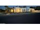 Modern home exterior with desert landscaping and illuminated entryways at twilight at 7001 E Joan De Arc Ave, Scottsdale, AZ 85254