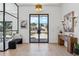 Bright foyer with herringbone wood floors and steel and glass front door at 7001 E Joan De Arc Ave, Scottsdale, AZ 85254