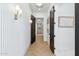 Hallway featuring herringbone-patterned floors, wainscoting, and modern lighting at 7001 E Joan De Arc Ave, Scottsdale, AZ 85254