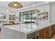 Bright kitchen with a spacious island, modern appliances, and access to the outdoor living space at 7001 E Joan De Arc Ave, Scottsdale, AZ 85254
