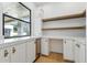 Bright kitchen with stainless steel appliances, sleek white cabinets, and open shelving for storage at 7001 E Joan De Arc Ave, Scottsdale, AZ 85254