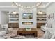 Stylish living room featuring a modern fireplace, built-in shelves, and comfortable seating arrangements at 7001 E Joan De Arc Ave, Scottsdale, AZ 85254