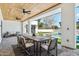 Charming covered outdoor dining area overlooking the pool and lush backyard at 7001 E Joan De Arc Ave, Scottsdale, AZ 85254