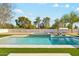 Beautiful backyard pool and spa with classic black and white tile, surrounded by lush greenery at 7001 E Joan De Arc Ave, Scottsdale, AZ 85254