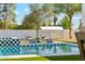 Luxurious backyard featuring a sparkling pool with checkered tile accents and stylish lounge chairs at 7001 E Joan De Arc Ave, Scottsdale, AZ 85254