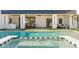 Gorgeous pool featuring a black and white tiled spa and stylish outdoor dining and lounging areas at 7001 E Joan De Arc Ave, Scottsdale, AZ 85254