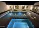 A luxurious pool and hot tub illuminated at night, perfect for relaxation and entertainment at 7001 E Joan De Arc Ave, Scottsdale, AZ 85254