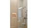 Modern shower with wood-look tile, glass enclosure, niche, and bronze fixtures at 7001 E Joan De Arc Ave, Scottsdale, AZ 85254