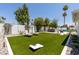 Backyard featuring artificial turf, in-ground pool, outdoor seating and mature trees at 7020 E Friess Dr, Scottsdale, AZ 85254