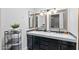 Bathroom featuring a double sink vanity, granite counters, and decorative lighting at 7020 E Friess Dr, Scottsdale, AZ 85254