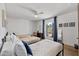 Bright bedroom featuring a ceiling fan, decorative window, and two beds at 7020 E Friess Dr, Scottsdale, AZ 85254