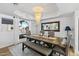 Elegant dining room featuring a modern chandelier, large window, and a stylish dining set at 7020 E Friess Dr, Scottsdale, AZ 85254