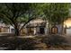Evening view of home showcasing mature trees, desert landscaping, and a cozy ambiance at 7020 E Friess Dr, Scottsdale, AZ 85254