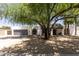 Traditional home with mature landscaping, gravel front yard, and a two-car garage at 7020 E Friess Dr, Scottsdale, AZ 85254
