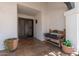 Charming front porch with tiled flooring, wooden bench, and potted plants at 7020 E Friess Dr, Scottsdale, AZ 85254