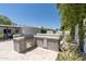 Modern outdoor kitchen featuring a built-in grill, concrete countertops, and storage at 7020 E Friess Dr, Scottsdale, AZ 85254