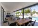 Covered outdoor patio with inground pool, dining table and ping pong table at 7020 E Friess Dr, Scottsdale, AZ 85254