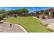 Expansive backyard with lush green turf, perfect for outdoor activities and relaxation in a serene setting at 7445 E Eagle Crest Dr # 1111, Mesa, AZ 85207
