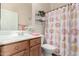 Well-lit bathroom featuring a shower with a patterned curtain and a wooden vanity with a sink at 7445 E Eagle Crest Dr # 1111, Mesa, AZ 85207