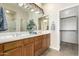Bathroom featuring double sinks, a large mirror, and wood cabinetry at 7445 E Eagle Crest Dr # 1111, Mesa, AZ 85207
