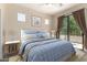 Serene bedroom with balcony access, a ceiling fan, and neutral tones, creating a tranquil retreat at 7445 E Eagle Crest Dr # 1111, Mesa, AZ 85207