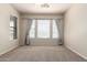 An empty bedroom with multiple large windows and blinds at 7445 E Eagle Crest Dr # 1111, Mesa, AZ 85207