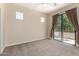 Bright bedroom featuring neutral walls, carpet, and sliding glass doors opening to a private patio at 7445 E Eagle Crest Dr # 1111, Mesa, AZ 85207