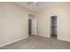 Bedroom featuring neutral walls, carpet, with a ceiling fan, and multiple doors leading to different areas at 7445 E Eagle Crest Dr # 1111, Mesa, AZ 85207