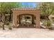Community cabana provides a shaded gathering spot, featuring a stone table with bench seating at 7445 E Eagle Crest Dr # 1111, Mesa, AZ 85207