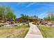 Elegant home exterior with manicured lawn, desert landscaping, and inviting walkway, showcasing curb appeal at 7445 E Eagle Crest Dr # 1111, Mesa, AZ 85207