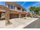 Charming townhome showcasing its garages, desert landscaping, and views of the surrounding neighborhood at 7445 E Eagle Crest Dr # 1111, Mesa, AZ 85207