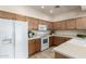 Bright kitchen featuring wood cabinetry, modern appliances, and tiled flooring at 7445 E Eagle Crest Dr # 1111, Mesa, AZ 85207