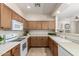 An open kitchen design features wood cabinets and white appliances at 7445 E Eagle Crest Dr # 1111, Mesa, AZ 85207