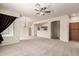 Open-concept living space with neutral colors, carpeted floors, and access to the kitchen and staircase at 7445 E Eagle Crest Dr # 1111, Mesa, AZ 85207