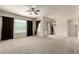 Large living room features a ceiling fan, plush carpeting, and access to outdoor views at 7445 E Eagle Crest Dr # 1111, Mesa, AZ 85207
