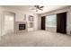 Spacious living room with a cozy fireplace, neutral carpeting, and large window with natural light at 7445 E Eagle Crest Dr # 1111, Mesa, AZ 85207