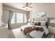 Bright main bedroom with a ceiling fan, a large window, and plush bedding for ultimate comfort at 7445 E Eagle Crest Dr # 1111, Mesa, AZ 85207
