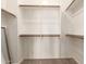 Bright walk-in closet with white walls, carpeted floors, and wooden clothing rods provides ample storage at 7445 E Eagle Crest Dr # 1111, Mesa, AZ 85207