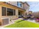 View of the outdoor backyard with an artificial grass, patio, and barbeque grill at 754 E Harper St # 102, Gilbert, AZ 85297