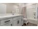 Well-lit bathroom featuring a shower and single sink vanity with black hardware at 754 E Harper St # 102, Gilbert, AZ 85297