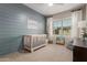 Well-appointed bedroom with crib, blue accent wall, and whimsical decor at 754 E Harper St # 102, Gilbert, AZ 85297