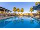 Luxurious community pool offering a refreshing swimming experience with palm trees and a grilling station at 754 E Harper St # 102, Gilbert, AZ 85297
