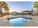 Spa-like community pool and jacuzzi surrounded by palm trees, lounge chairs, and clear blue skies at 754 E Harper St # 102, Gilbert, AZ 85297