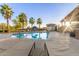 Resort-style pool area with palm trees, lounge chairs, and well-maintained landscaping at 754 E Harper St # 102, Gilbert, AZ 85297