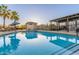 Inviting community pool with a clear blue surface, featuring ample seating and shaded pergola at 754 E Harper St # 102, Gilbert, AZ 85297