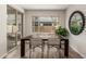 Bright dining room features wood floors, a modern table and sliding door to the outdoor patio at 754 E Harper St # 102, Gilbert, AZ 85297