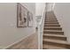 Bright hallway boasts wood-look tile flooring, staircase, and stylish wall art at 754 E Harper St # 102, Gilbert, AZ 85297