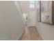 Hallway with wood-look tile leads to powder room; accented with elegant wall art at 754 E Harper St # 102, Gilbert, AZ 85297