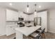 Bright, open kitchen with modern appliances, white cabinetry, and sleek center island at 754 E Harper St # 102, Gilbert, AZ 85297